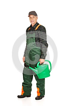 Workman holding green watering can
