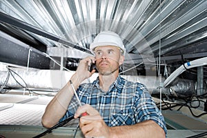 workman inspecting ceiling