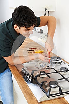 Workman Installing Gas Cooker In New Kitchen