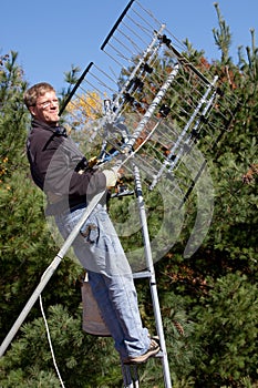 Workman installing HDTV digital antenna