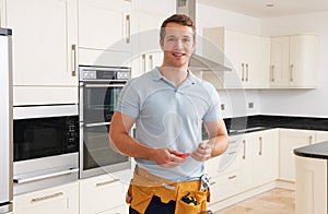 Workman Installing Luxury Fitted Kitchen