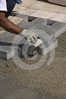 Workman laying sidewalk