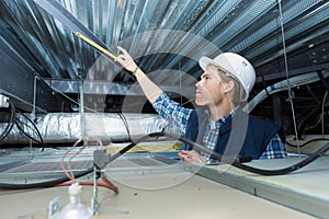 Workman looking into roofspace