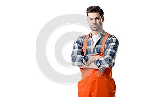 workman in orange overall standing with folded arms