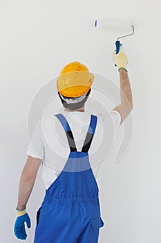 Workman painting wall