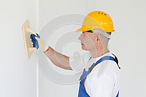 Workman polishing wall