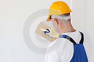 Workman polishing wall