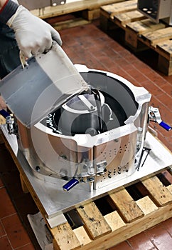 Workman pouring liquid silicon into a mold