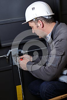 workman repairing garage door