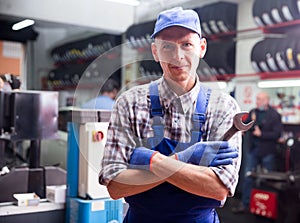 Workman standing near car at auto repair