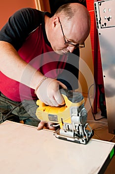 Workman using jigsaw photo