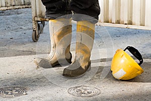 Workmans muddy boots and helmet photo