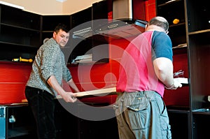 Workmen fitting kitchen photo