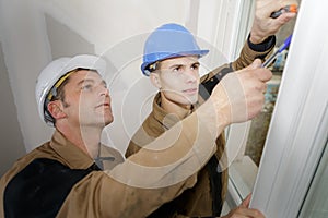 Workmen fitting new window photo
