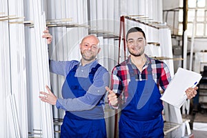 Workmen inspecting window frames