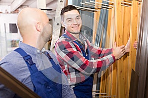 Workmen inspecting window frames