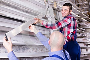 Workmen inspecting window frames