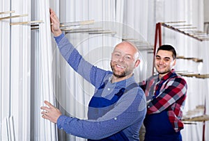 Workmen inspecting window frames