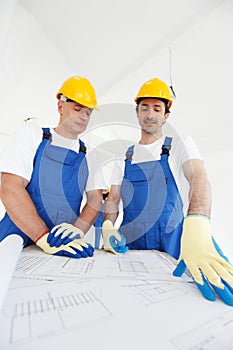Workmen looking at house design