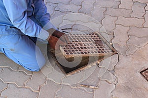 Workmen opening a manhole to repair a water leak