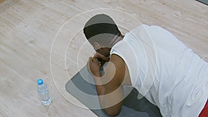 Workout. Black sport man doing plank exercise for tights at gym. Male athlete exercising on yoga mat, planking and