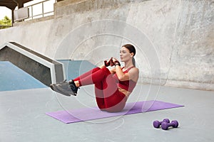 Workout. Fitness Girl Doing Abdominal Exercise On Yoga Mat At Outdoor Stadium. Fit Woman With Sexy Muscular Body.