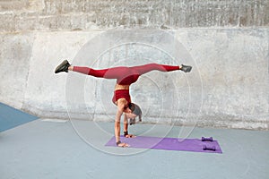 Workout. Fitness Girl Standing On Hands. Fit Woman In Fashion Sporty Outfit Doing Split Twine In Air.