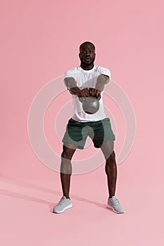 Workout. Man doing kettlebell swing exercise, sports training