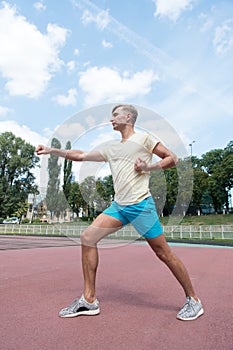 Workout of man punching sunny outdoor