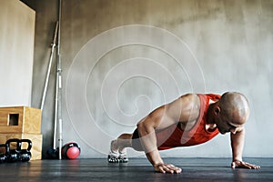 Workout, muscular and man doing gym studio push up for exercise, health performance and sports training for muscle