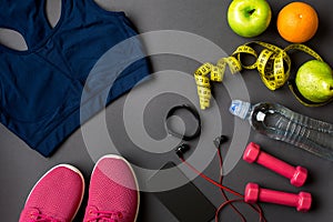 Workout plan with fitness food and equipment on gray background, top view