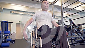 Workout process of a male wheelchair invalid in a gym