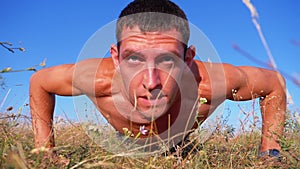 Workout. pushups fitness man doing push-ups outside on nature. Slow motion