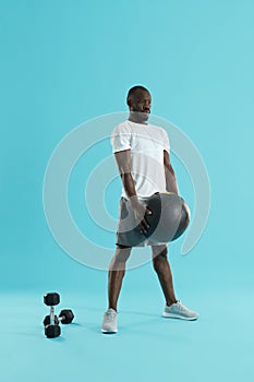 Workout. Sports man exercising with med ball, training