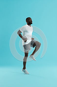 Workout. Sports man exercising, running on spot, cardio training