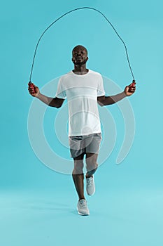 Workout. Sports man in sportswear exercising on jumping rope