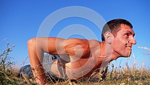 Workout. Strong Man doing Push-ups with Claps Outside on Nature. Slow Motion