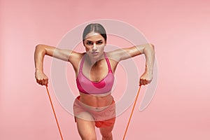 Workout. Woman Training With Resistance Bands On Pink Background