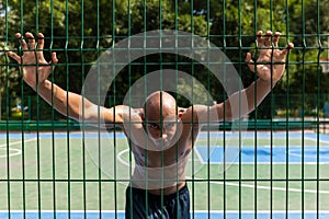 Workout. Young strong man, male basketball player training at street public stadium, sport court or palyground outdoors