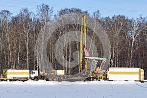 Workover rig working on a previously drilled well trying to restore oil production through repair. Russia photo