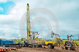 Workover rig working on a previously drilled well trying to restore production through repair. Service of oil-extracting