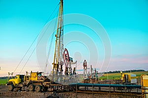 Workover rig working on a previously drilled well trying to restore production through repair. Service of oil-extracting