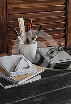 Workplace and accessories for training, education and work. Books, magazines, notebooks, pens, pencils, tablet, glasses.