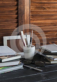 Workplace and accessories for training, education and work. Books, magazines, notebooks, pens, pencils, tablet, glasses