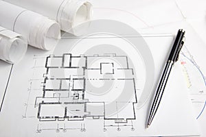 Workplace of architect - Architectural project, blueprints, rolls and tablet, pen, divider compass on plans. Engineering