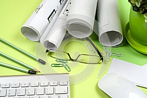 Workplace of architect - rolls and plans. Construction background.