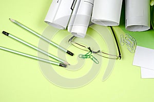 Workplace of architect - rolls and plans. Construction background.