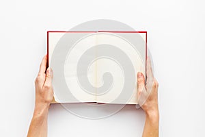 Workplace with book in hands for reading on white background flatlay mockup