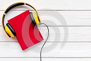 Workplace with books and headphones on white wooden background flatlay mockup