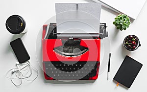 Workplace with bright red vintage typewriter